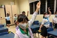 students learning the hand movements from each traditional dance.